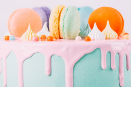round layer cake with blue and pink frosting topped with macarons