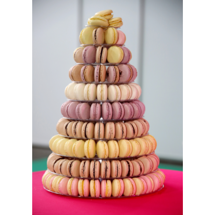 closeup assortment of lots of multicoloured macarons arranged in a 10 tier pyramid shaped tower